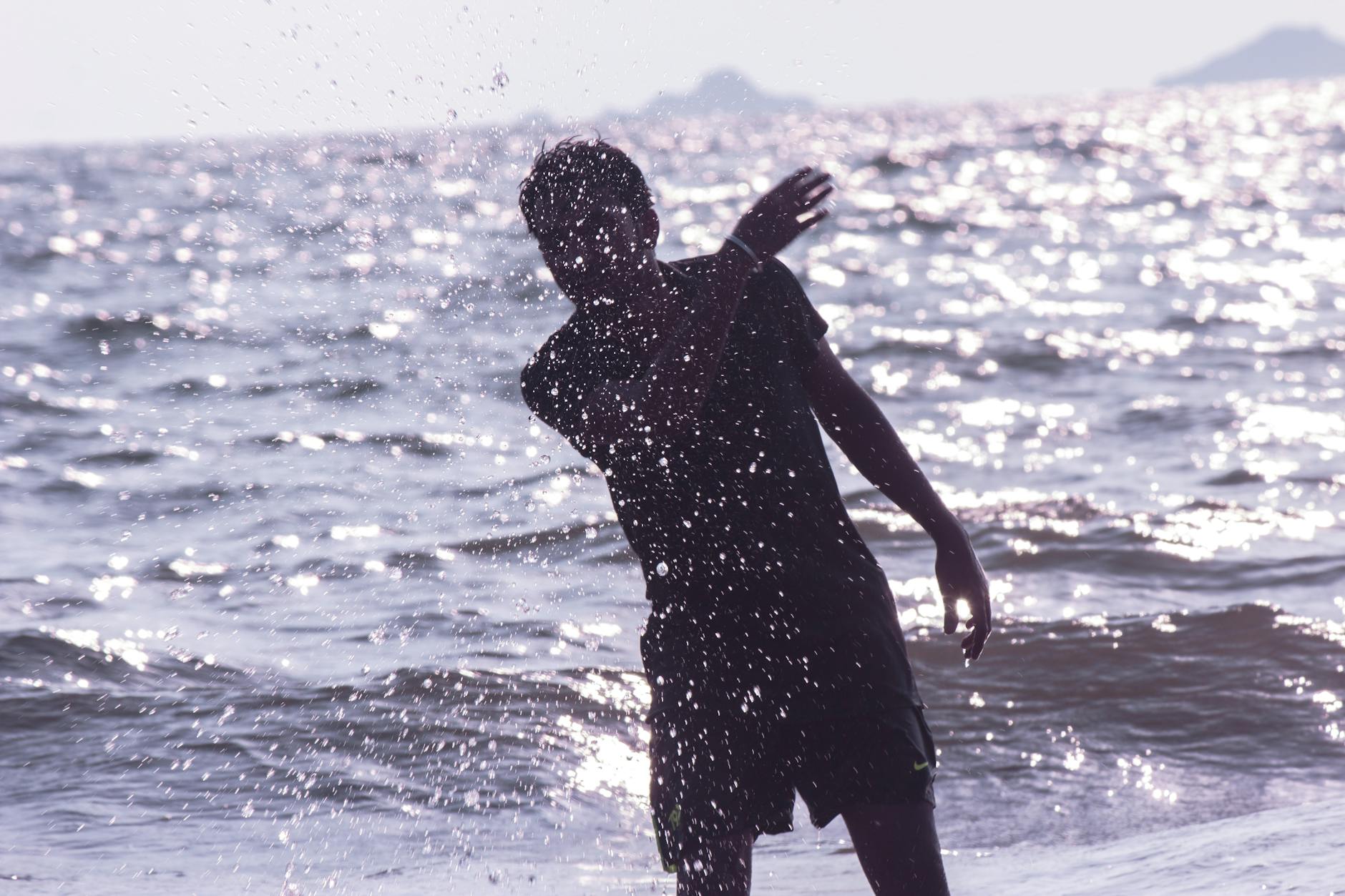 A silhouette of a person radiating with bright mint energy.